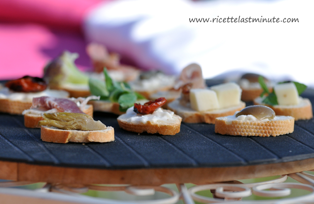 Appetizers made with a baguette of bread and colored toppings