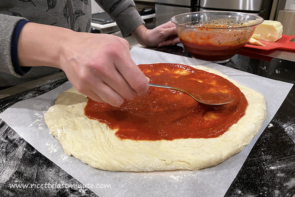 Dough spread with fingers and seasoned