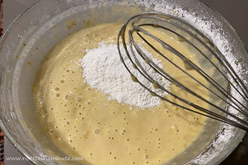 Sifted flour added to the orange cake mixture