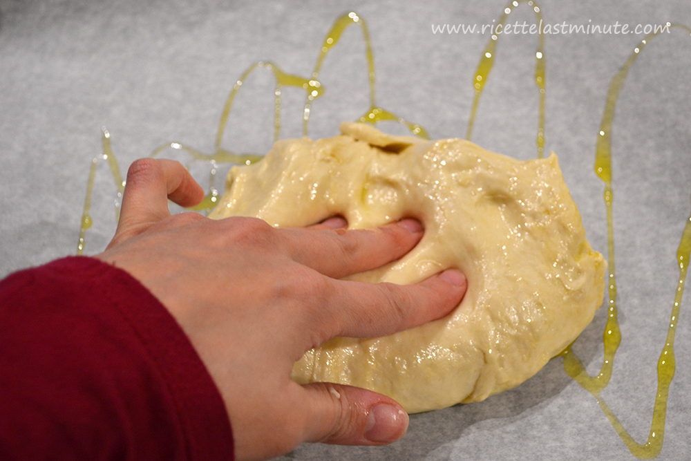Spreading the Genoese focaccia dough