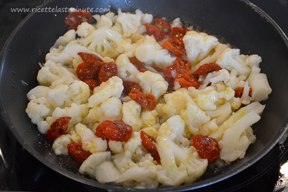 Cavolfiori e pomodori secchi in padella con olio, sale e pepe